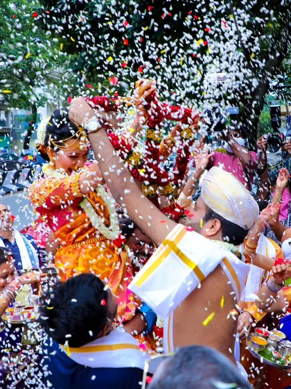 There's nothing like the pure joy of a wedding celebration. I love capturing these candid moments, like this traditional flower shower during a Muhurtam ceremony. It’s all about real emotions and vibrant colors.