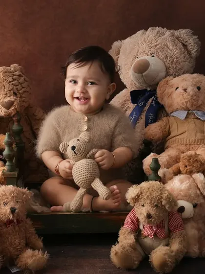 A party of bears. Our teddy bear picnic is a classic and heartwarming theme. This little one, nestled among his furry friends, is the picture of pure, cuddly joy.