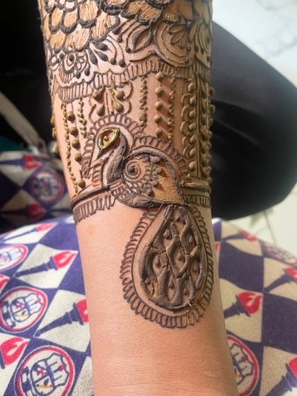 Another look at the detailed peacock design. The fine lines and shading bring the bird to life.