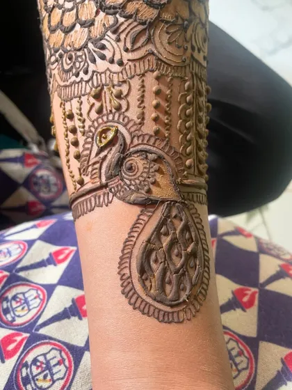 Another look at the detailed peacock design. The fine lines and shading bring the bird to life.