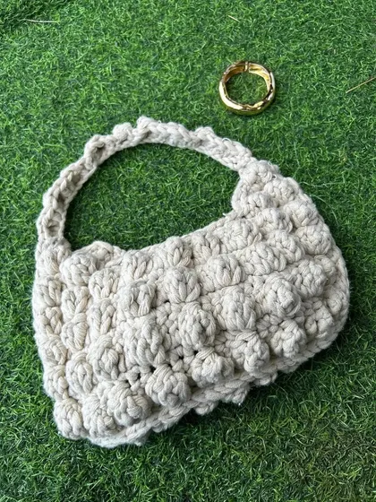 A flat-lay of the puff stitch bag. This view really highlights the bubbly, three-dimensional texture of the puff stitches.