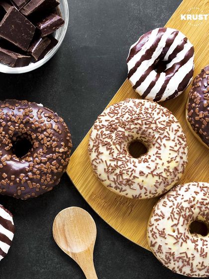 A delicious-looking spread of chocolate-themed doughnuts. This image is perfect inspiration for our 'Doughnut Delights' decorating workshop.