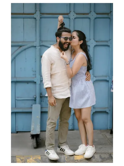 A photoshoot should be fun, a chance to be yourselves. This playful moment against a bright blue door in Fort Kochi perfectly captures the couple's happy and carefree connection. It’s these real interactions that make the best portraits.