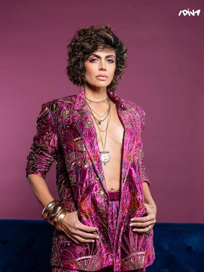 A close-up from the iDiva shoot with Mandira Bedi. The focus is on her powerful expression, complemented by the intricate details of the embroidered jacket.