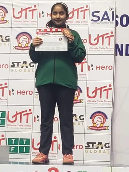 A close-up of Akanksha with her national-level bronze medal, a significant achievement for our academy.
