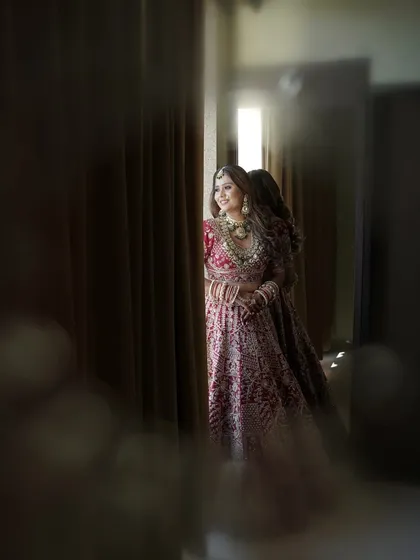 A full-length portrait showcasing the complete bridal look, from the elegant draping to the layered necklaces.