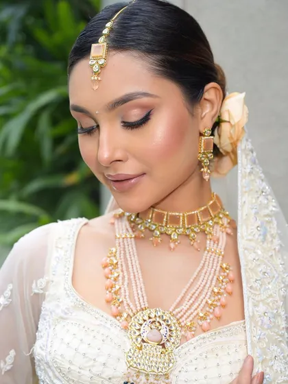 Eyes closed, this shot highlights the soft, shimmery eyeshadow and the perfect, dewy highlight on the cheekbones. This is the essence of a bridal glow.