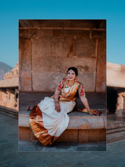 A stunning bridal portrait set against the ancient stone of a temple. The contrast between the bride's vibrant attire and the historic backdrop creates a powerful image.
