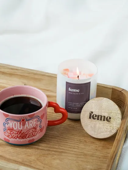 A cozy morning scene with our Rose Velvet & Oud holographic jar candle and a cup of coffee. The perfect way to start the day.