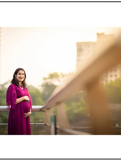 A solo portrait on a bridge, with the city skyline in the background, blending urban and natural elements.