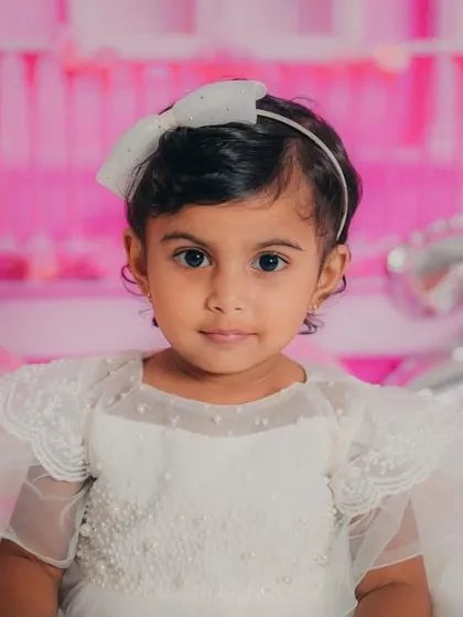 Another stunning close-up portrait, capturing her innocent gaze and the intricate details of her pearl-adorned dress.