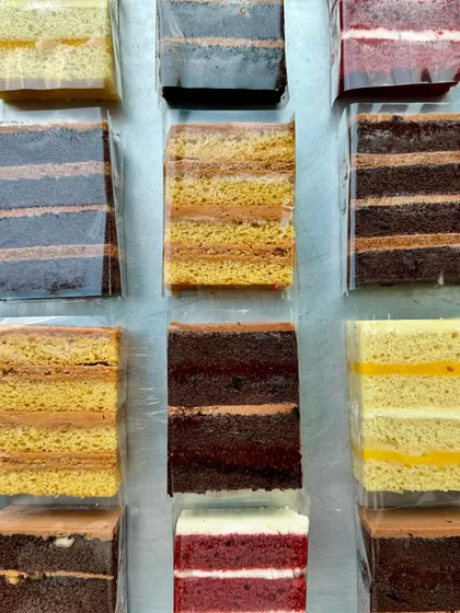 A close-up of the beautiful layers in our cake slices. You can see the different sponges and fillings in each flavour.