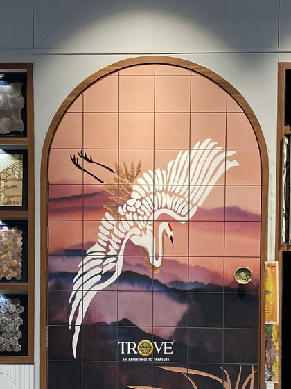 We believe every part of your home can be beautiful. This custom tile mural, featuring a crane against a soft sunset, transforms a simple doorway into an arched gateway of art, showcasing our ability to blend design with architecture.