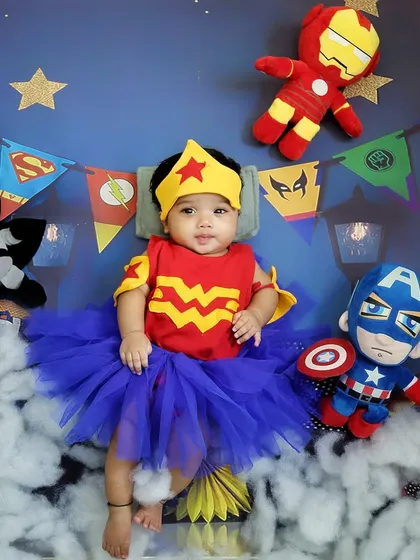 A little Wonder Woman resting among the clouds. This superhero-themed shoot is perfect for capturing the strength and cuteness of your little hero.