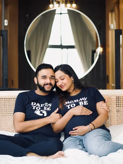 A babymoon or a cozy indoor shoot is a wonderful alternative to a traditional outdoor session. This couple chose to celebrate with matching "Mommy to be" and "Daddy to be" shirts, creating a fun and personal memory. These sessions are perfect for capturing your excitement in a comfortable, intimate setting.