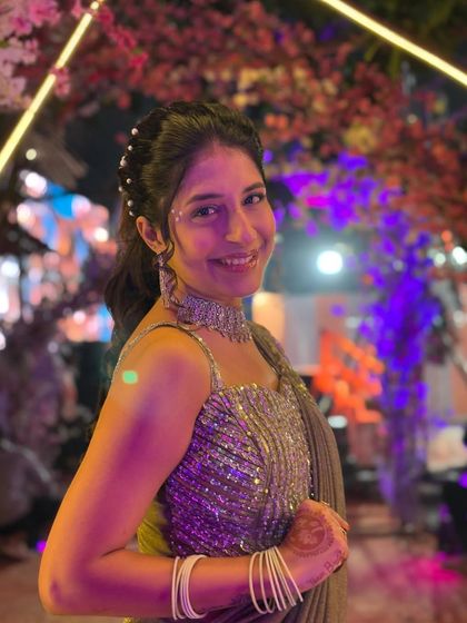 A close-up shot highlighting the sparkling blouse and the elegant pearl-studded hairstyle, which can be complemented by my rental jewellery. This look is all about effortless glamour.