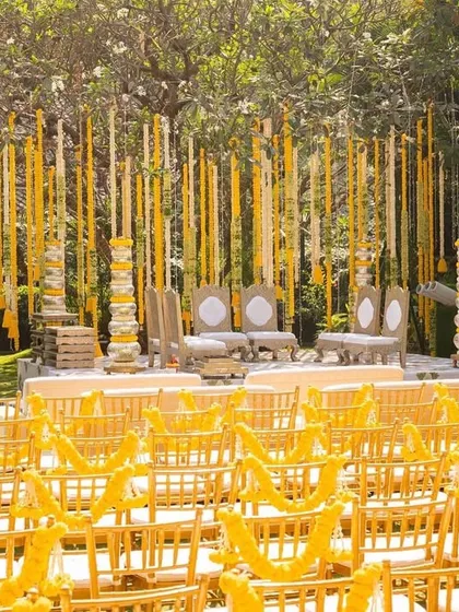 The 'Tree of Love' mandap we designed for Siddhi and Rushabh. We transformed a beautiful champa tree into the ceremony's centerpiece by suspending thousands of fragrant rajnigandha strings, creating a truly unique and natural setting.