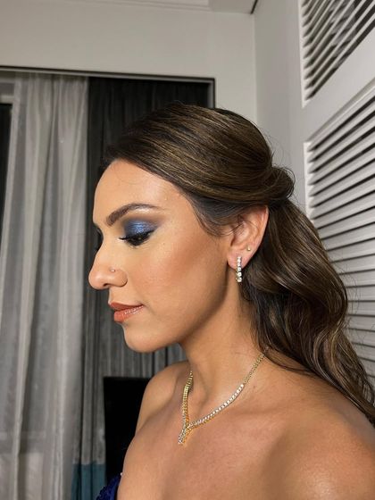 A close-up of the bride's glam look, with the soft waves complementing her bold eye makeup.