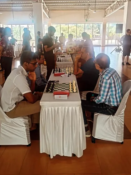 We bring the competitive spirit of chess to communities with our inter-society tournaments. Here, adult players are deep in thought during a weekend competition held at a local clubhouse.
