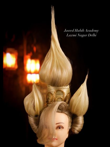Inspired by architectural forms, this unique hairstyle demonstrates our students' ability to think outside the box and construct complex, gravity-defying designs.