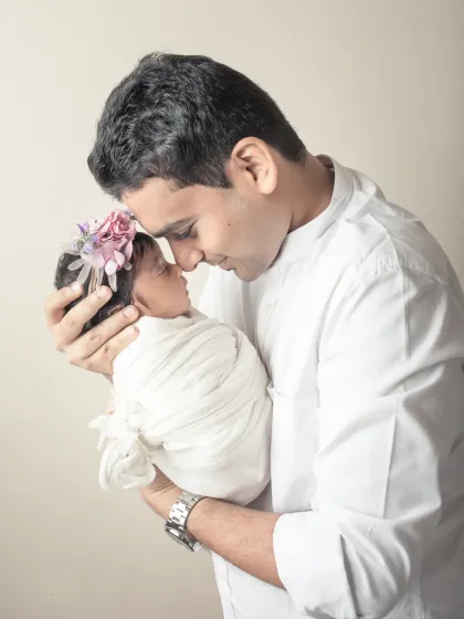 A father and his newborn daughter, nose to nose. This incredibly tender portrait captures the beginning of a lifelong bond.