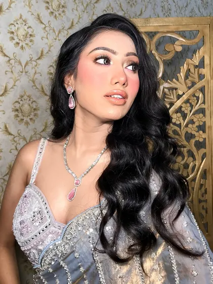 The side profile highlights the elegant drop earrings that complete the set.