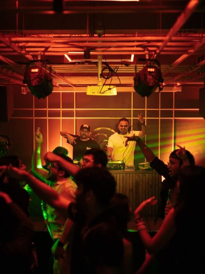 Me and my partner DJ with our hands up, hyping the crowd.