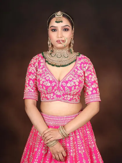 The full bridal ensemble. This look, created during my pro course, shows how to balance a vibrant pink lehenga with elegant makeup for a stunning result.