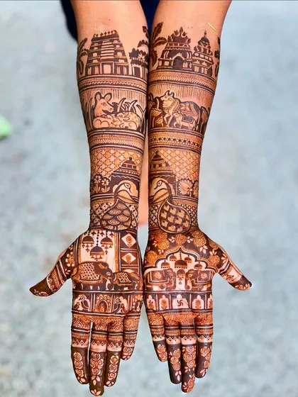 An Extravaganza package design featuring temple architecture and animal motifs. This style is perfect for brides wanting a grand, story-rich mehendi.