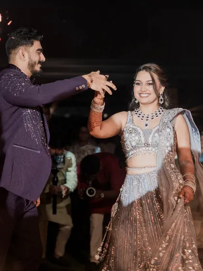 The couple's first dance. This action shot captures the movement of her lehenga and the joy on their faces.