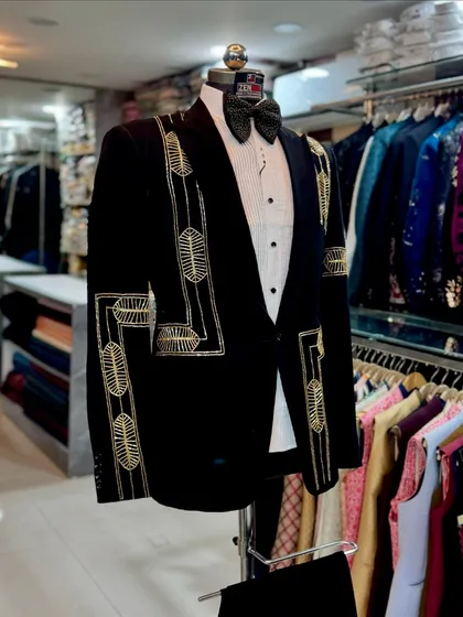 The black and gold tuxedo seen from the side, displayed in my Lajpat Nagar store. This image gives clients a sense of the in-store experience and the quality they can expect.