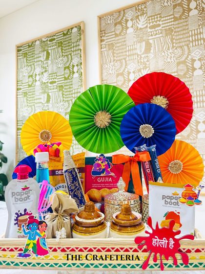 The complete traditional Holi hamper, ready to be gifted. It combines nostalgic drinks, traditional sweets, and playful elements like a pichkari, all presented in a custom-branded wooden tray that can be reused long after the festival is over.