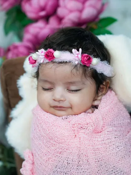 A sweet, sleepy smile from a newborn wrapped in pink. These are the moments that make my job the best in the world.