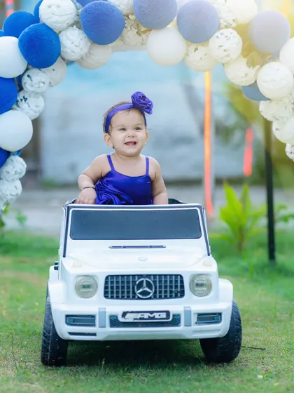 Pre-birthday shoots are so much fun. Here, the birthday girl enjoys her own little ride, creating a playful and memorable outdoor portrait that's full of personality.