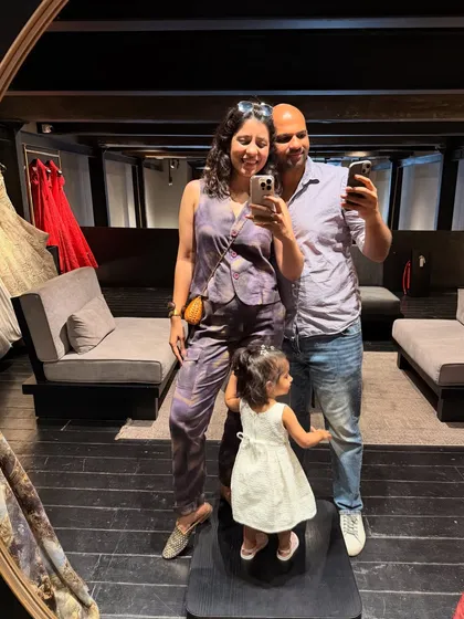 A family that takes mirror selfies together. Shopping for wedding outfits is a team effort, and I make sure it's a fun experience for everyone, including the little ones.