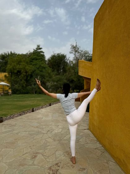 Finding balance and strength against the warm ochre walls of Anvaya during one of our holistic yoga and wellness retreats.