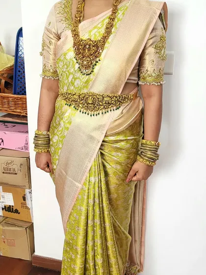 This is a close-up of the Kanchipattu silk saree I draped for bride Megha's Bheegara Oota. The focus is on the crisp pleats and how the drape complements her heavy temple jewelry.