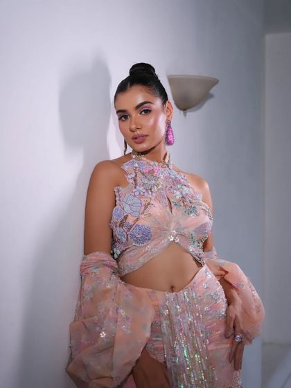 A pastel peach gown with dramatic, floor-length balloon sleeves. A true statement piece.