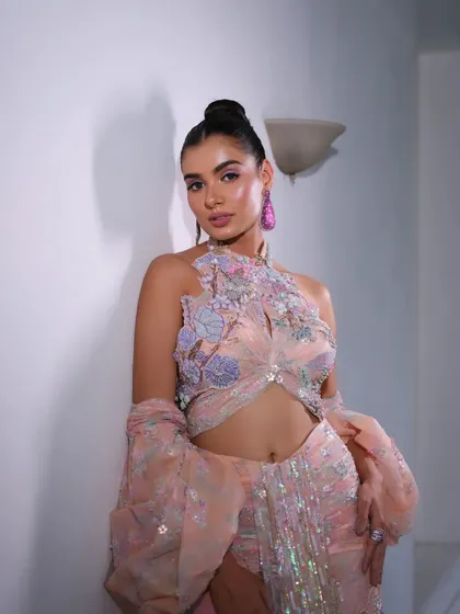 A full-length view of the peach gown. The unique silhouette and dramatic sleeves make this a true statement piece that I loved styling.