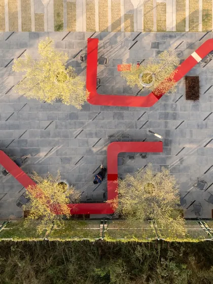 An aerial view of the Red Ribbon Plaza, a sculptural seating installation we designed for a tech campus. This playful, undulating steel plate transforms from a bench to a table, creating a dynamic "people space" that is both functional public furniture and a striking piece of urban art.