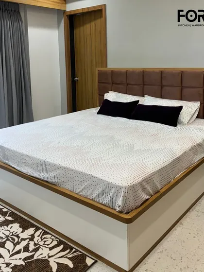 A clean and contemporary design featuring a brown tufted headboard set against a crisp white and wood-trimmed bed frame. This style is perfect for creating a serene and comfortable retreat with a touch of understated elegance.