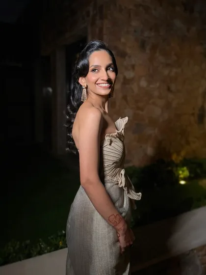 The complete look, showcasing how a vintage inspired hairstyle and a modern outfit can come together for a truly unique and elegant evening style.
