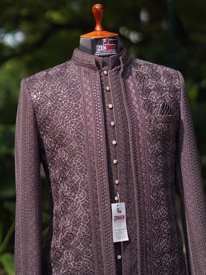 A close-up of the Jodhpuri suit, focusing on the button placket and the fine, geometric embroidery. The mother-of-pearl buttons add a touch of classic luxury.