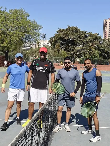 A men's doubles foursome ready for their match. The Ad In Tennis Open is a great way to test your partnership and strategy in a real match setting.
