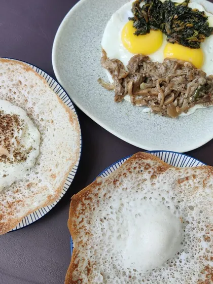 A perfect Sunday breakfast featuring our Pandi Curry. It's served here with soft appams, fried eggs, and sautéed oyster mushrooms for a complete and hearty Kodava-style meal.