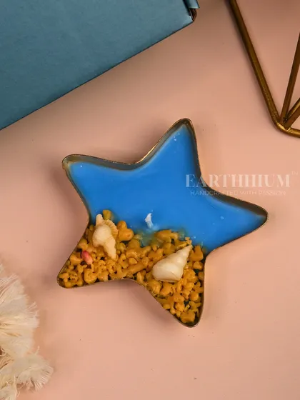 For those who love the sea, I created this starfish-shaped Urli candle. It features a blue ocean wax base with tiny shells, bringing a coastal vibe right into your home.