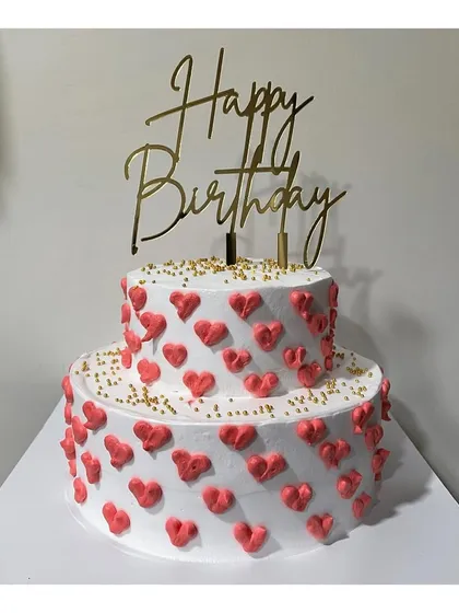 A simple yet sweet one kg two-tier cake in our popular Chocolate Ganache flavor. The cake is covered in little red hearts, making it a perfect choice for an anniversary or a romantic celebration.