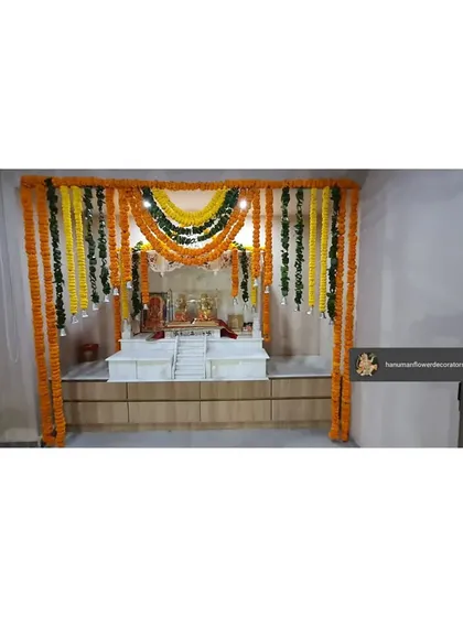 We created this traditional pooja space within an office using marigold and leaf garlands. The setup provides a serene and auspicious corner for prayers during festivals.