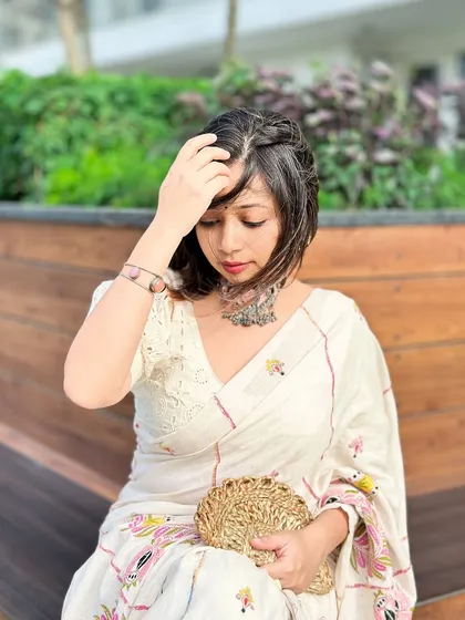 A quiet, introspective moment in a beautiful off-white kantha stitch saree. The silver choker adds a touch of bohemian elegance.