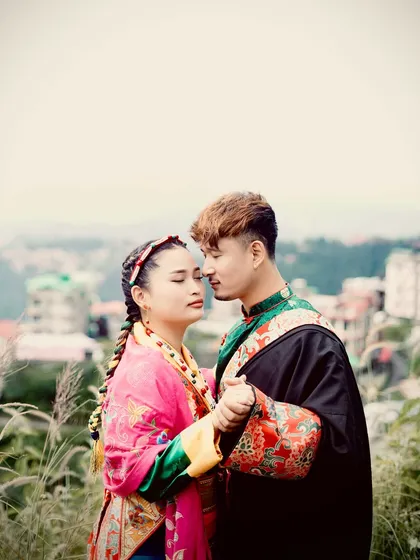 An intimate and romantic pose with the couple in their traditional dress against a soft, natural background. This shot focuses on their connection and the beauty of their cultural heritage.
